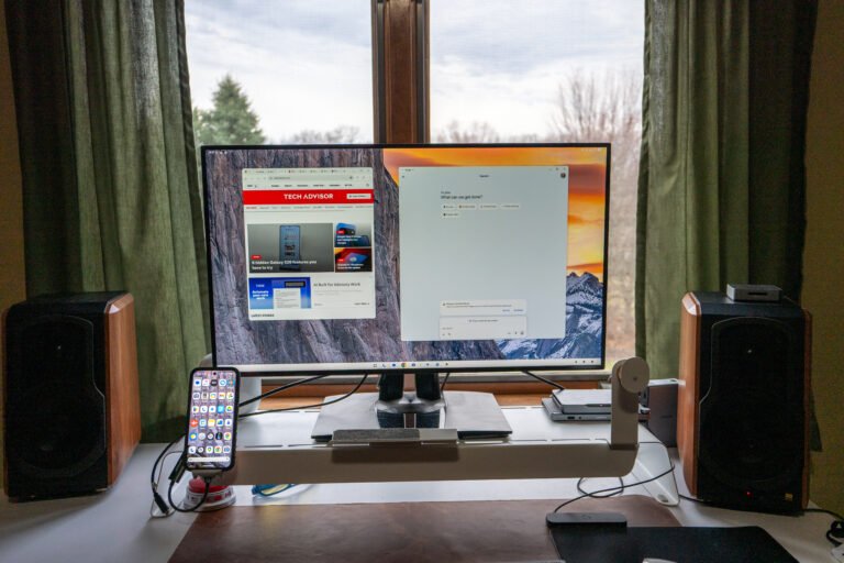 A person using Android Desktop on a monitor with a keyboard and mouse, with a cityscape in the background, showcasing the flexibility and productivity of this innovative feature in the UK