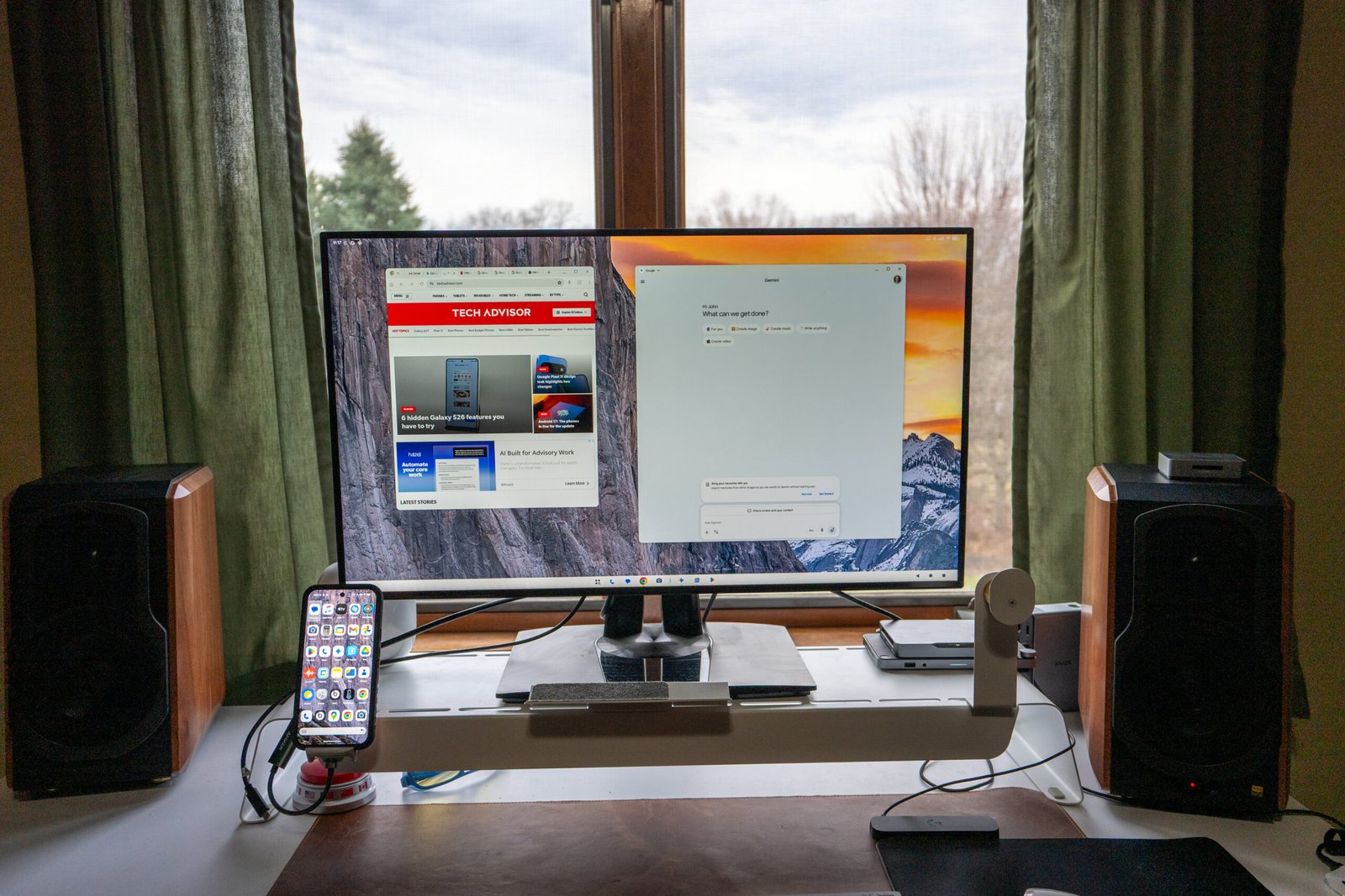 A person using Android Desktop on a monitor with a keyboard and mouse, with a cityscape in the background, showcasing the flexibility and productivity of this innovative feature in the UK