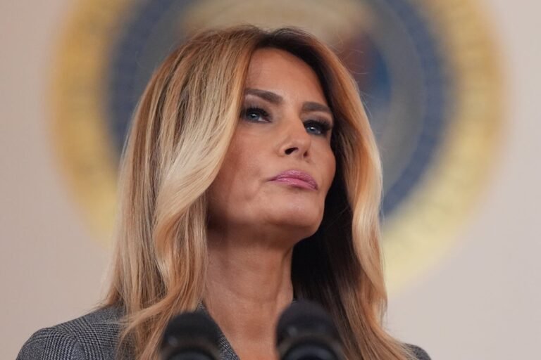 Melania Trump speaking at a public event, with a serious expression, surrounded by controversy and scandal, regarding her statement on Epstein