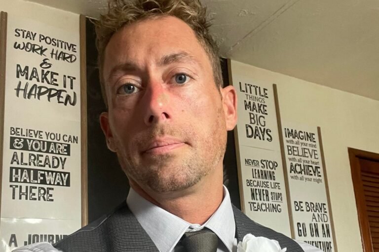 A person holding a sign that reads 'Support for Domestic Abuse Victims' with a subtle background colour, highlighting the importance of providing a safe and supportive environment for those affected by domestic abuse, with a focus on raising awareness and providing resources for victims