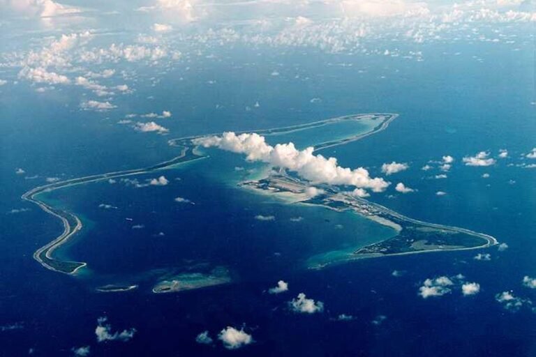 Aerial view of the Chagos Islands, with the ocean and coral reefs visible, highlighting the beauty and strategic importance of the islands, and the potential for resettlement and conservation efforts