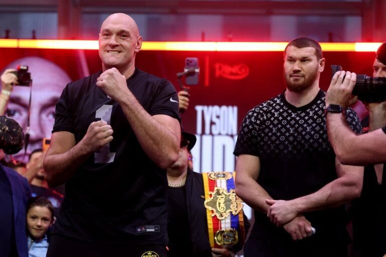 Tyson Fury and Makhmudov standing face to face in the ring, with the crowd cheering in the background. The atmosphere is electric, with the fighters ready to put on a show. Boxing fans from all over the world are eagerly anticipating the fight, which promises to be an unforgettable experience. Fury vs Makhmudov is the main event, with the undercard featuring a range of talented fighters. The odds are in favour of Fury, but Makhmudov is not to be underestimated.