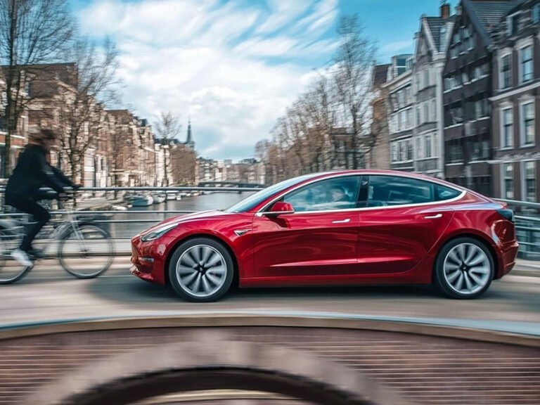 A Tesla vehicle equipped with Full Self-Driving technology navigates a complex road network in the UK, showcasing its advanced sensors and cameras. The technology has the potential to revolutionise the way we drive and improve road safety, with a monthly fee of €99 in Europe.