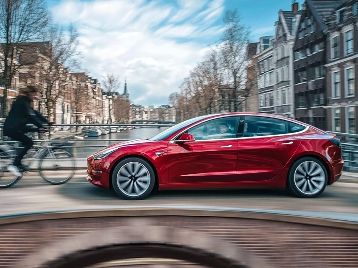A Tesla vehicle equipped with Full Self-Driving technology navigates a complex road network in the UK, showcasing its advanced sensors and cameras. The technology has the potential to revolutionise the way we drive and improve road safety, with a monthly fee of €99 in Europe.