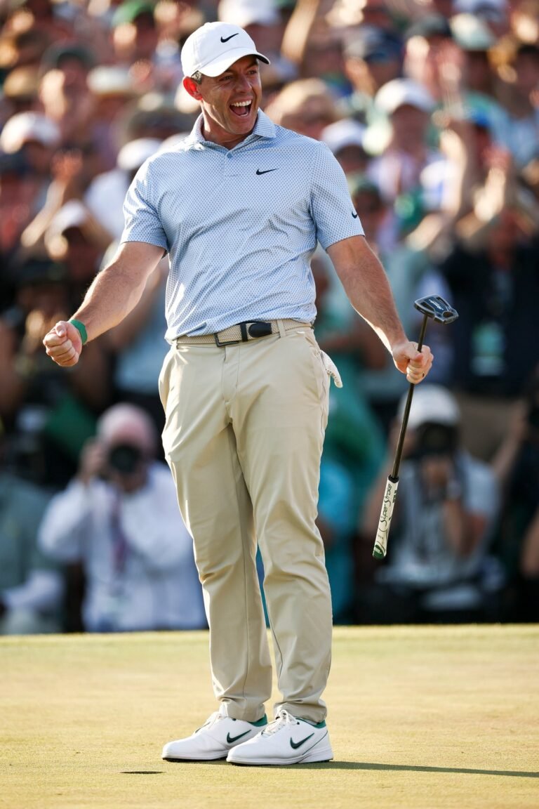 Rory McIlroy holding the Masters trophy, surrounded by cheering crowds, with a mix of colour and excitement in the background, highlighting his remarkable achievement in the golf tournament