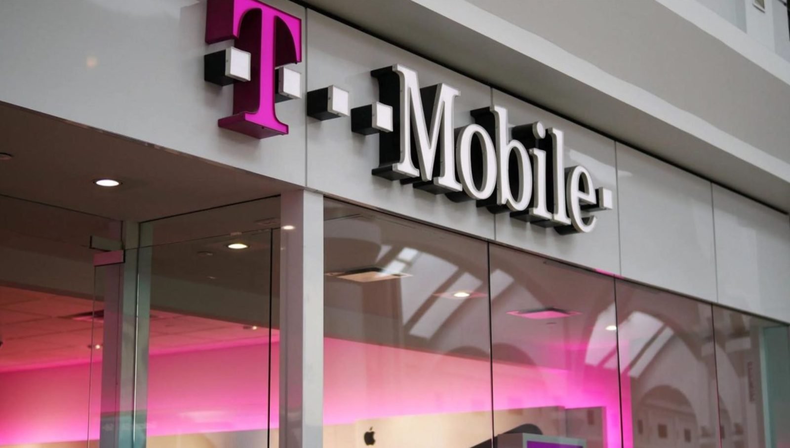 A person holding a smartphone with a shocked expression, symbolising the shock of receiving a massive T-Mobile bill, highlighting the importance of careful payment behaviour in the UK