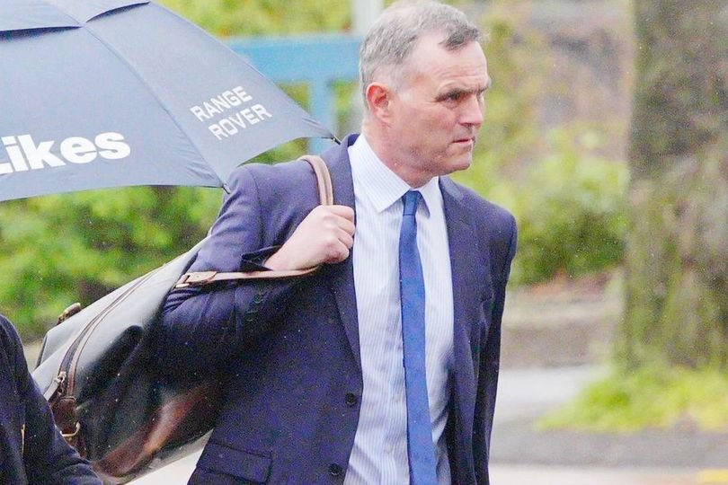 A photo of a hockey stick lying on the ground, with a dog walker in the background, highlighting the primary keyword 'hockey stick attack' in a descriptive and natural way, conveying the seriousness of the incident