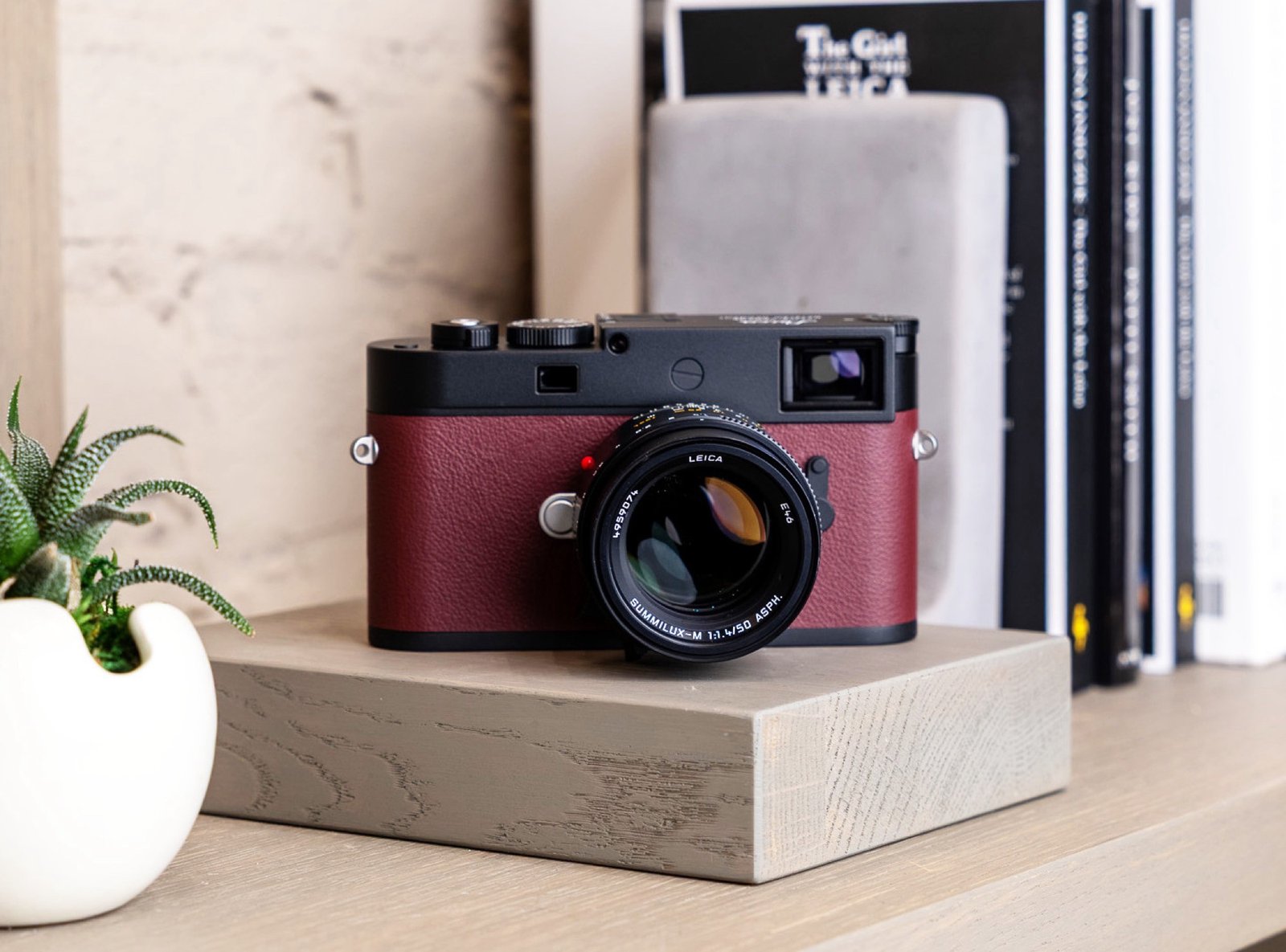 The Leica M11-P Limited Edition full-frame camera with a sleek silver finish and vibrant red leather cover, featuring a 60 megapixel sensor and 256 GB internal memory, perfect for photography enthusiasts in the UK