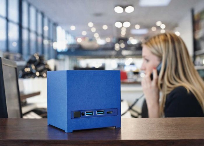 The Kubb Essential mini PC, a compact and colourful device with a cubical design language, featuring a powerful Intel CPU and up to 96 GB of RAM, perfect for use in the UK