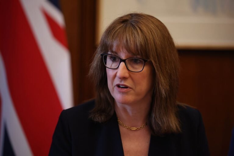 A UK military personnel in uniform, with a union jack flag in the background, symbolising the country's defence strategy and commitment to security, with a focus on the ongoing defence boost and its potential impact on UK security