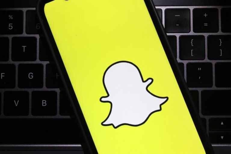 Snapchat's financial struggles lead to 16% workforce reduction, the company's logo and a graph showing declining revenue, the primary keyword is Snapchat layoffs