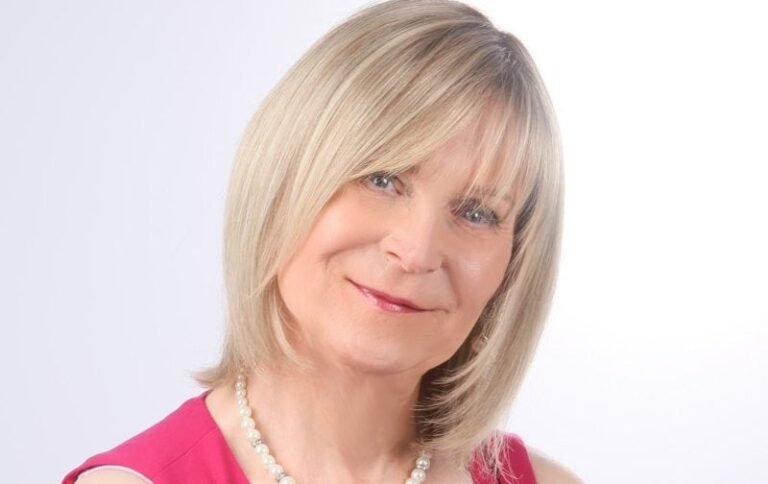 A trans woman speaking at an endometriosis awareness event, with a crowd of supportive people in the background, highlighting the importance of inclusivity and acceptance in the charity sector, particularly for those affected by endometriosis