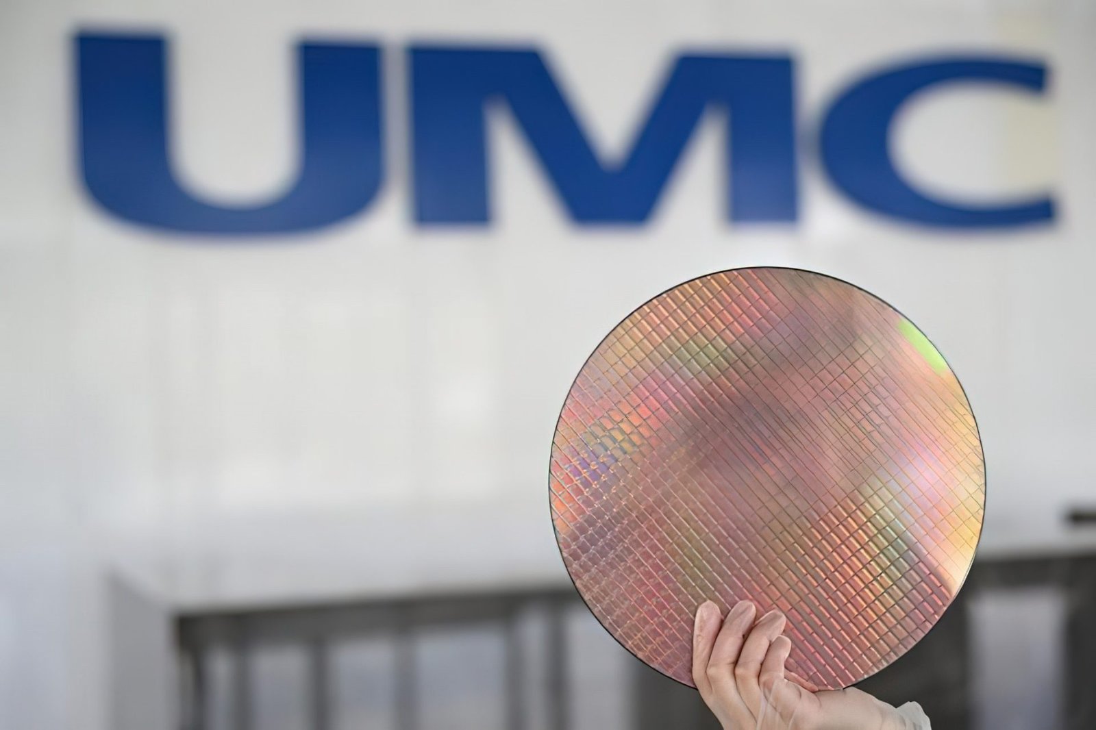A semiconductor wafer with microchips, representing the global chip shortage and its impact on the UK tech industry, with UMC's wafer price hike being a significant development