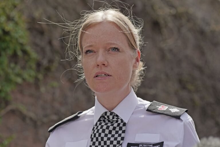 A floral tribute near the scene of the fatal Wimbledon school crash, which claimed the lives of two young girls, with a senior Met police officer among 11 individuals facing a probe, highlighting the importance of road safety and the need for a thorough investigation