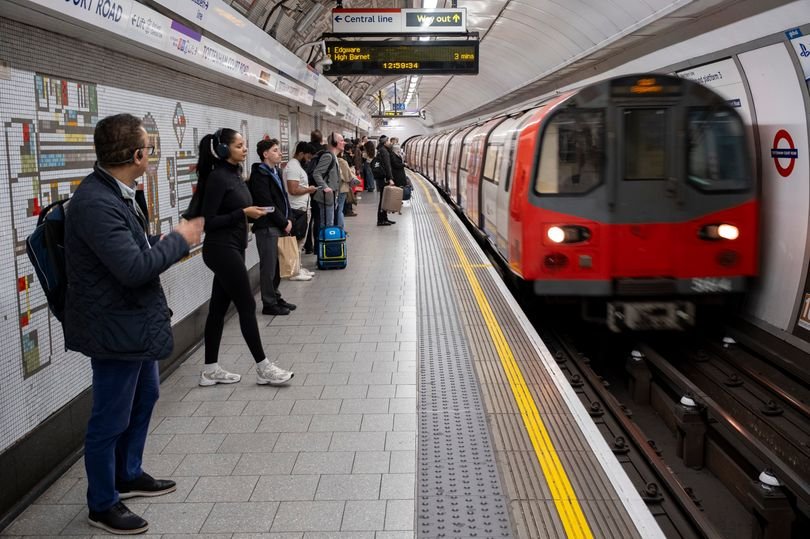 A crowded London Tube platform with a sign indicating a strike, highlighting the disruptions caused by the London Tube strikes in April 2026, with commuters waiting for alternative transport options