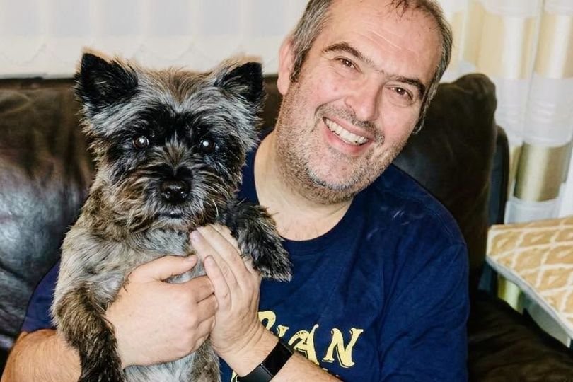 A photo of a dog on a walk with its owner, highlighting the importance of dog safety and responsible pet ownership, with a focus on preventing dog theft and ensuring the well-being of our furry friends