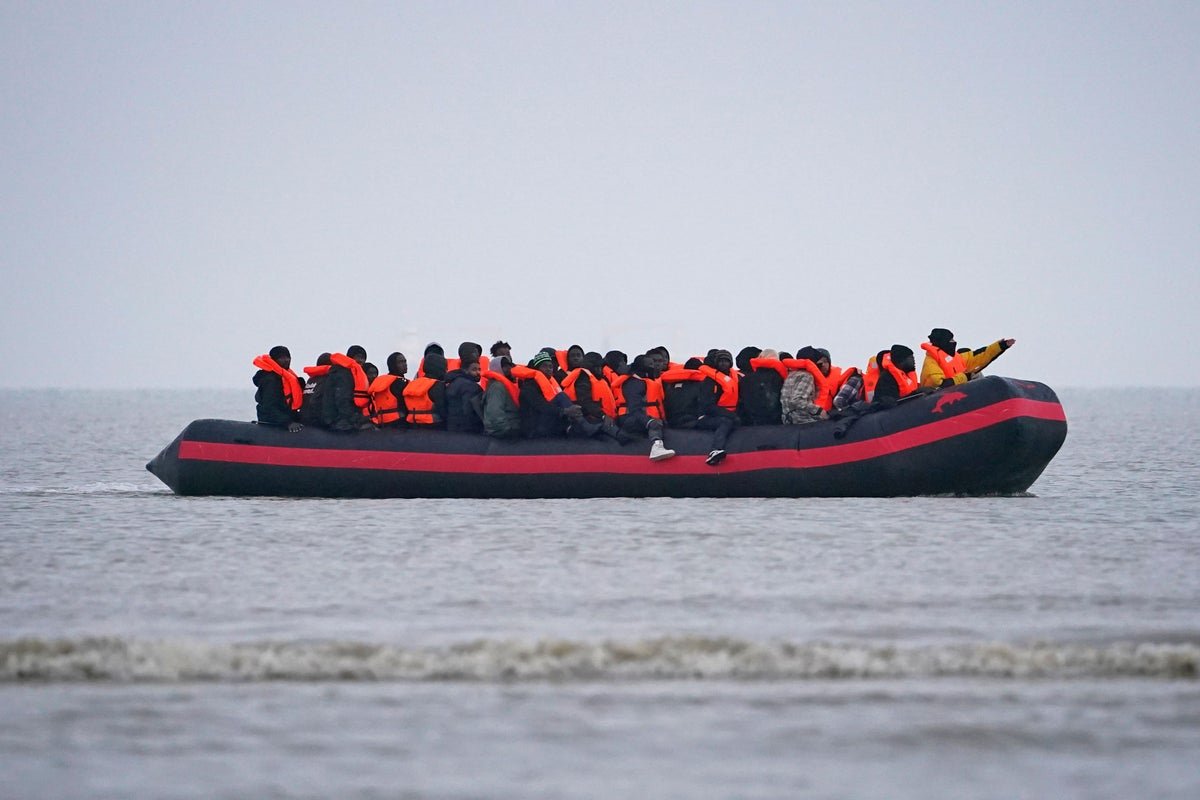 A photo of a migrant rescue operation in the English Channel, with a boat carrying migrants in the foreground and a coastguard vessel in the background, highlighting the primary keyword of Channel crossing