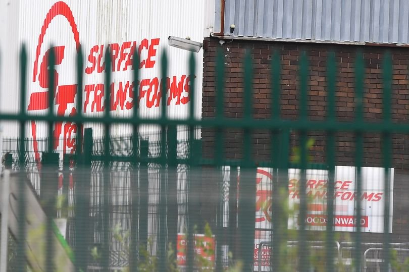 A descriptive image of a car company in administration, with a focus on the Merseyside car company collapse, highlighting the impact on the automotive industry and the potential job losses, with a colour palette that reflects the seriousness of the situation