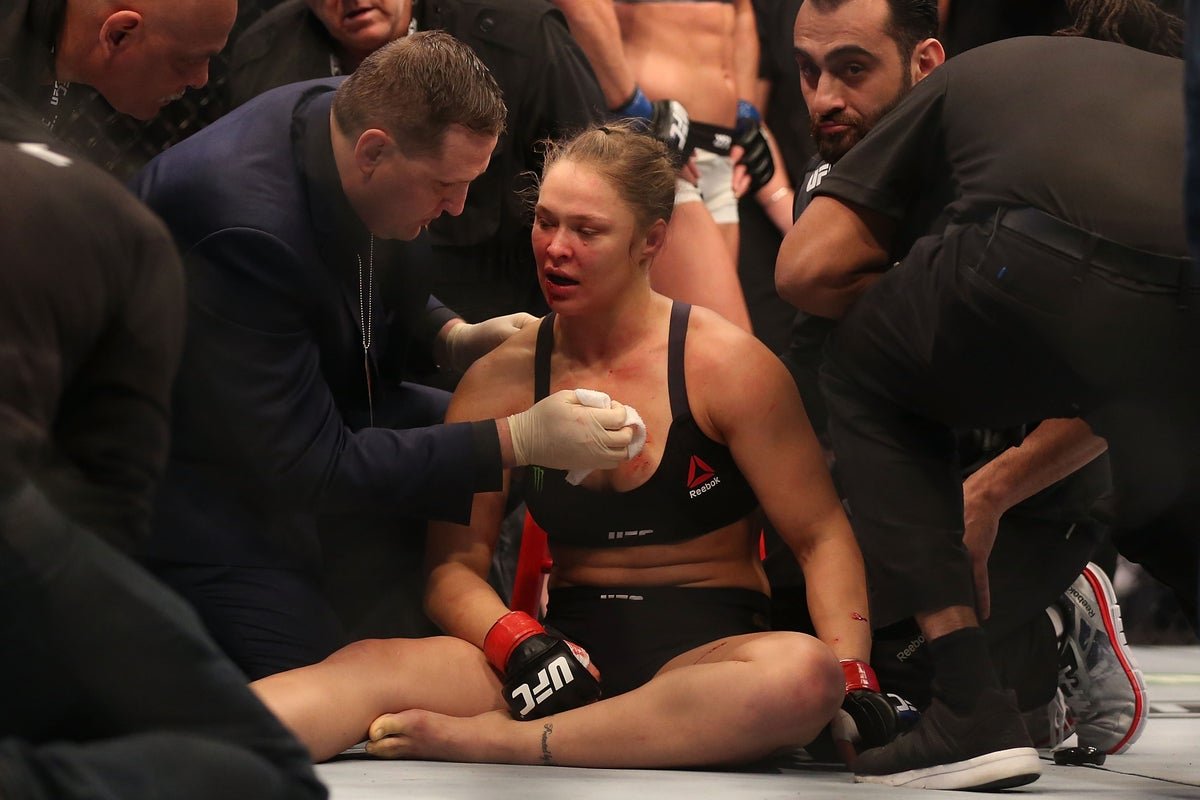 Ronda Rousey in action during her UFC fight against Holly Holm, showcasing her skill and determination in the octagon, a true pioneer of women's mixed martial arts