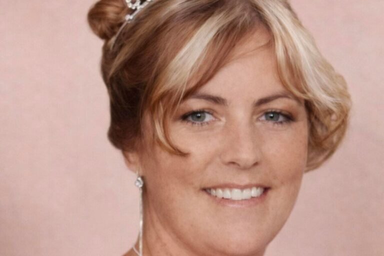 A photo of a woman looking at a picture of her loved one, with a mix of sadness and anger on her face, symbolising the traumatic experience of the family of a murdered woman