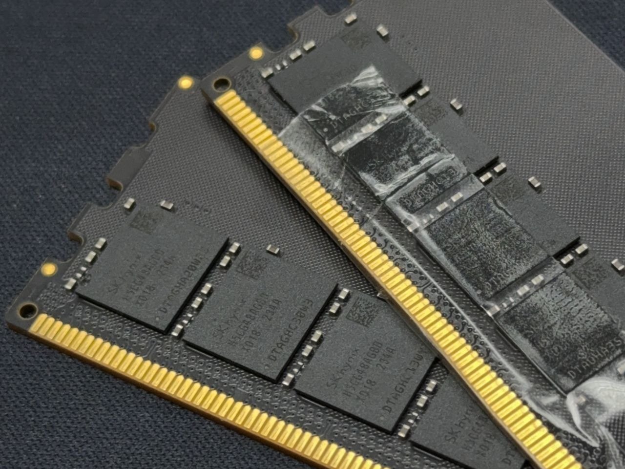 A close-up of a 16 GB DDR5 SO-DIMM module, with a blurry background of computer hardware components, representing the UK's first major price drop in DDR5 RAM this year, with a focus on the primary keyword phrase DDR5 RAM