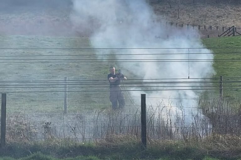 Firefighters responding to a fire at the West Lothian railway line, with smoke billowing into the air and emergency vehicles at the scene, highlighting the importance of railway safety