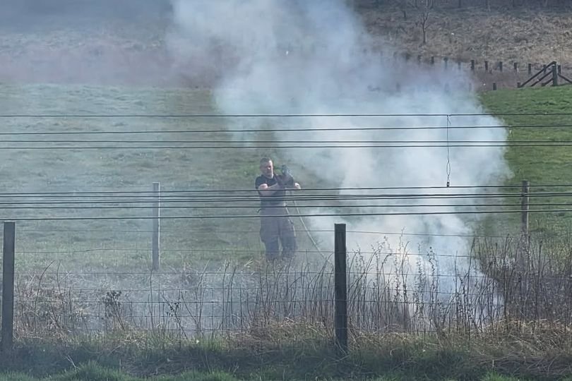 Firefighters responding to a fire at the West Lothian railway line, with smoke billowing into the air and emergency vehicles at the scene, highlighting the importance of railway safety