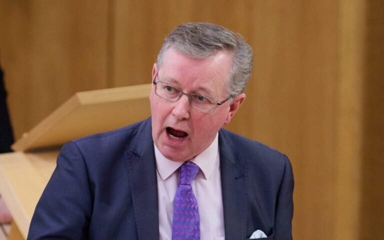 A benefits adviser standing next to a hire car, with a blurred background of a Scottish landscape, highlighting the SNP's spending on hire cars for benefits advisers, with a focus on the party's use of public funds and the environmental impact