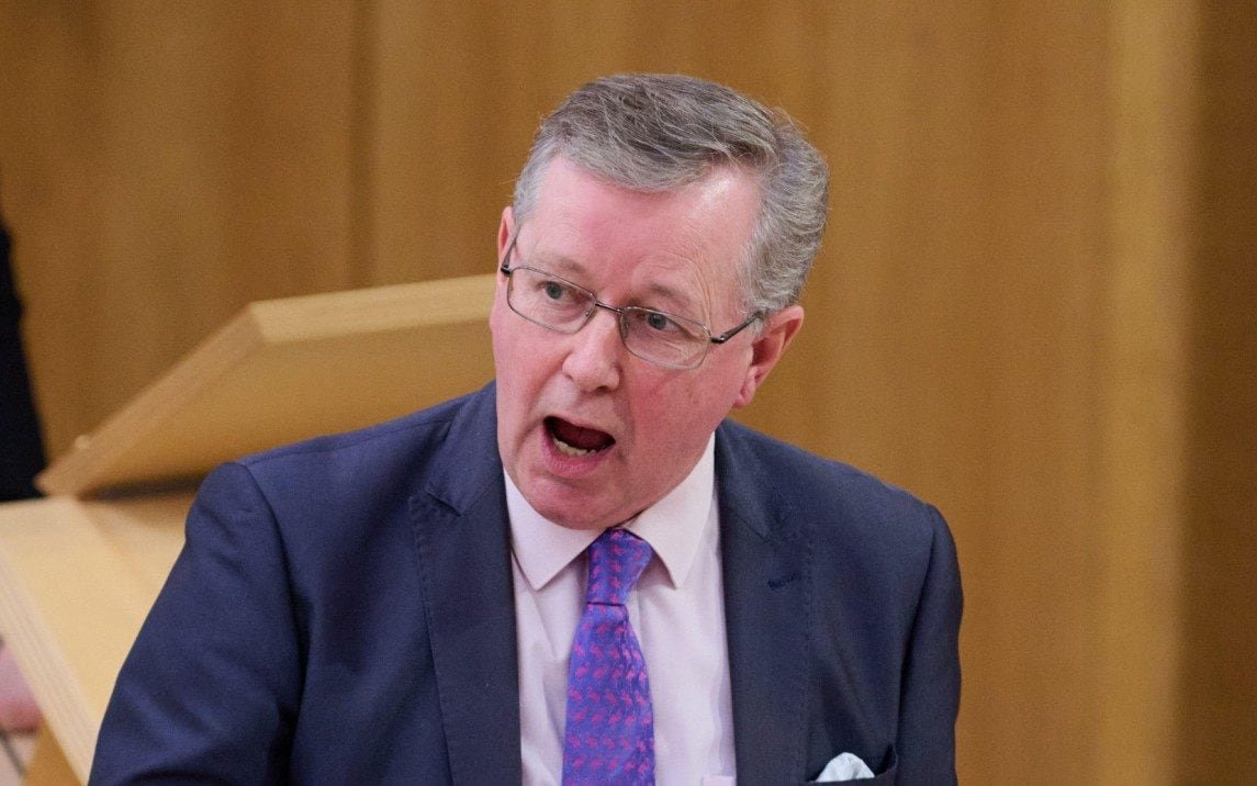 A benefits adviser standing next to a hire car, with a blurred background of a Scottish landscape, highlighting the SNP's spending on hire cars for benefits advisers, with a focus on the party's use of public funds and the environmental impact