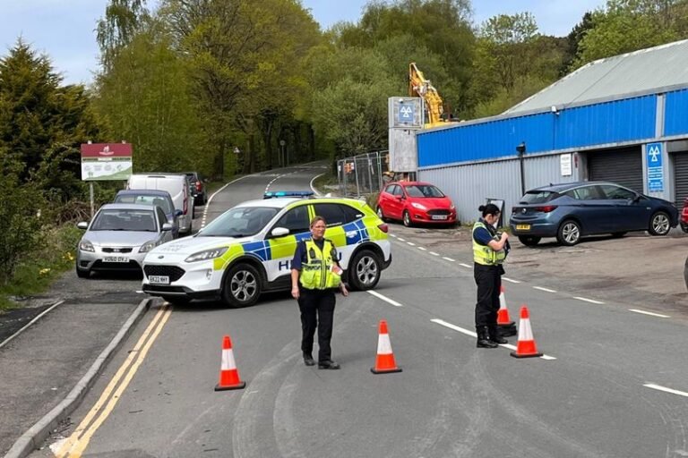 Aerial view of a Welsh mountain with a road closed due to an illegal rave, highlighting the impact on the community and environment, with a focus on public safety and the need for collective action to prevent such events