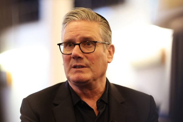 Keir Starmer standing in front of a shop, with a determined expression, as he vows to end the shop theft 'free-for-all', with a focus on supporting retailers and combating retail crime, the primary keyword being shop theft