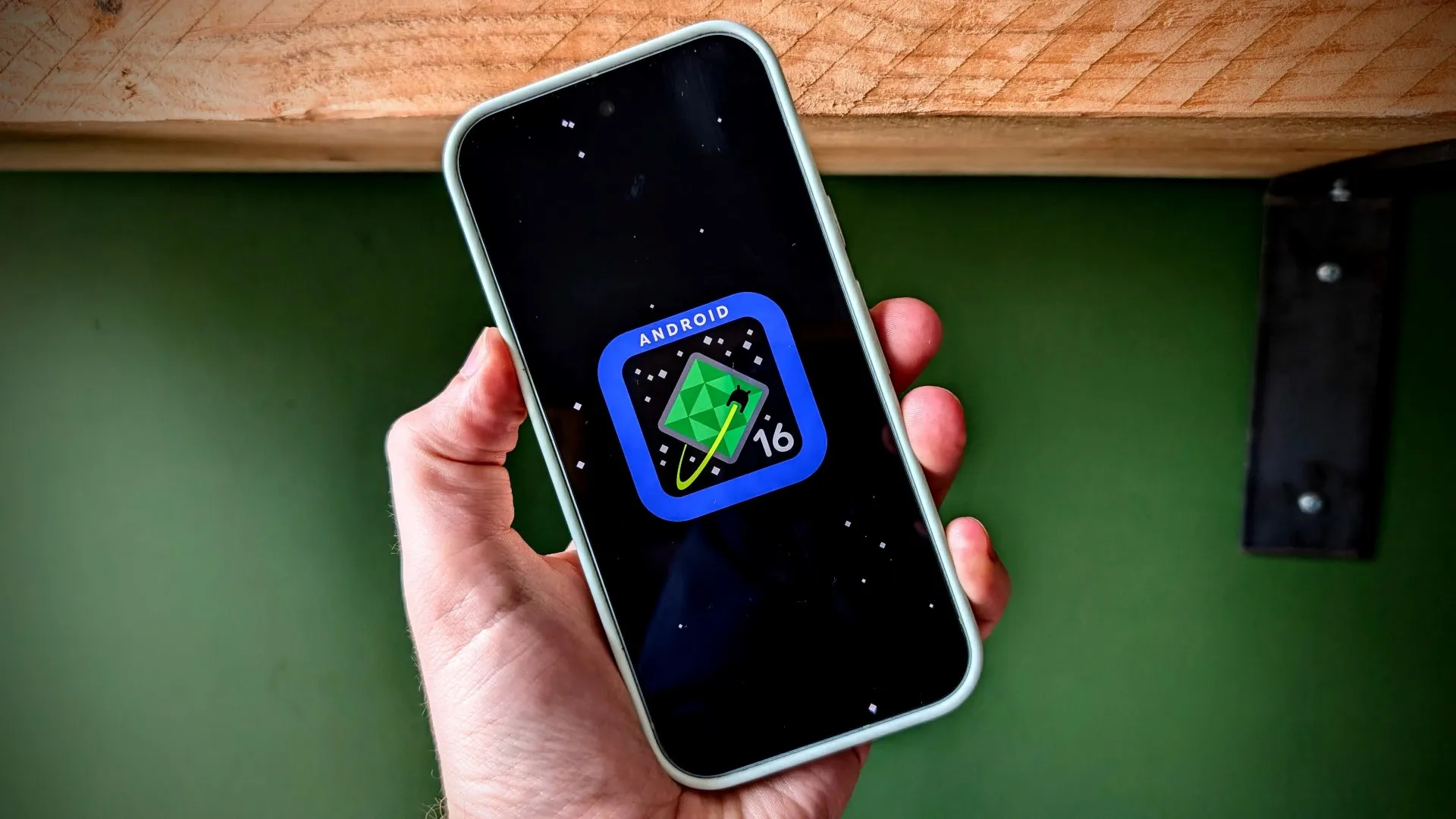 A person holding an old smartphone with a new interface, thanks to LineageOS 23 and Android 16. The screen displays a modern design with improved features and security updates, making the device look and feel like new again.