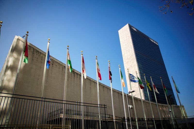 The United Nations building in New York, with the US and Iranian flags in the foreground, symbolising the clash between the two nations over nuclear non-proliferation and global security, with a focus on the US Iran conflict