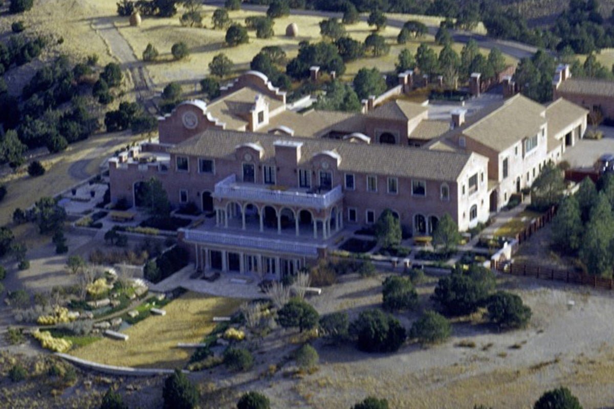 Aerial view of Jeffrey Epstein's New Mexico ranch, a luxurious estate shrouded in mystery and allegations of heinous crimes, with a focus on the primary keyword 'super predator'