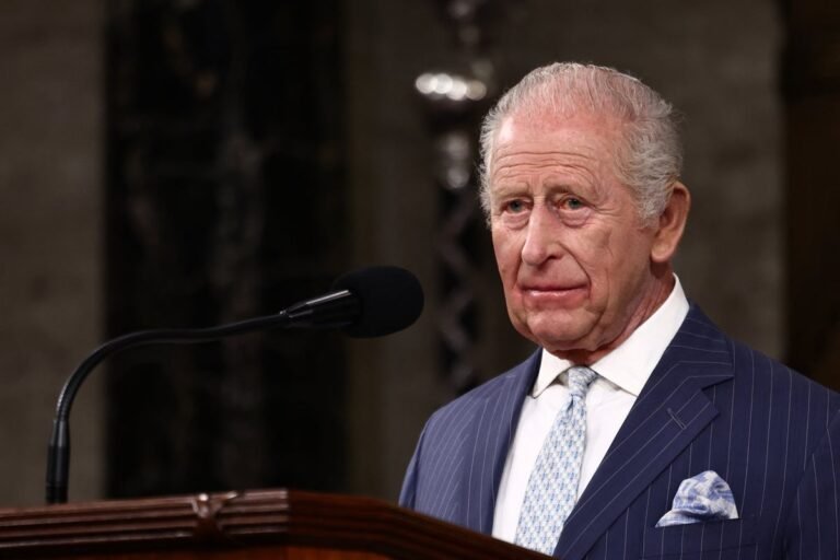 King Charles addressing the US Congress, with a backdrop of the American flag and a portrait of George Washington, as he references the importance of checks and balances in the US system of government, highlighting the special relationship between the UK and the US