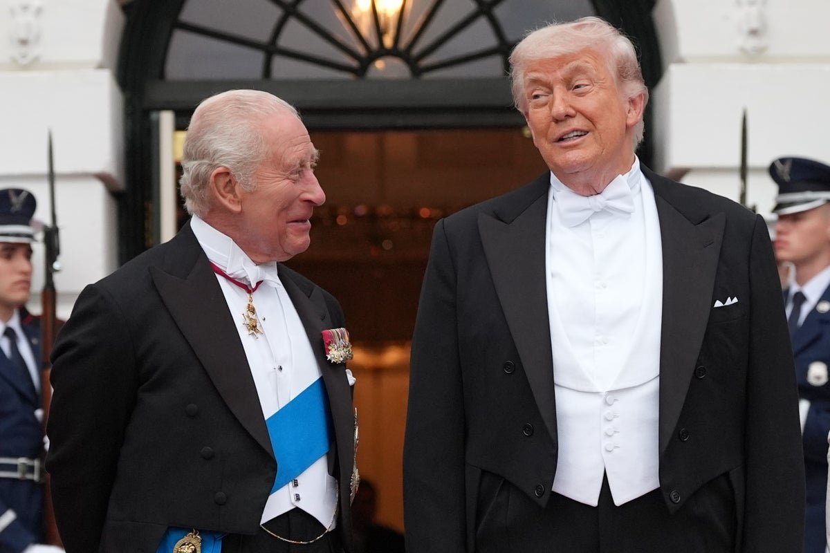 Donald Trump standing confidently with a powerful expression, symbolising his claim to be the most powerful person to ever live, with a subtle background of the White House, representing his position of power and leadership