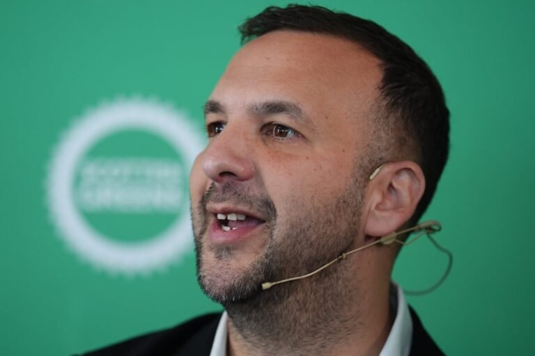 A sombre crowd gathers near the scene of the Golders Green terror attack, with police officers and emergency services present, as the community comes together to show their support for the victims and their families, with a mix of sadness and solidarity in the air, and a deep sense of colour and emotion