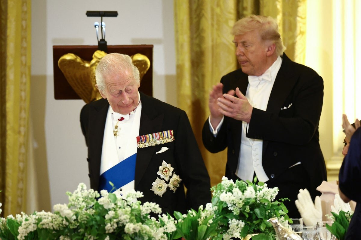 French President Emmanuel Macron responding to King Charles' comment about Donald Trump's French language skills, with a cheeky smile and a witty remark, showcasing his ability to think on his feet and diffuse tension with humour
