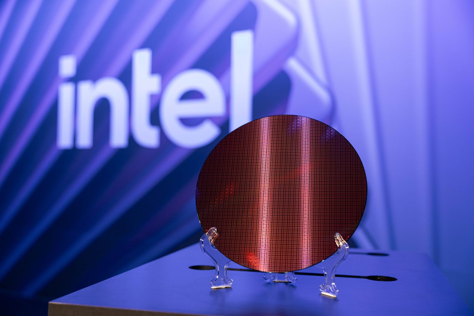Intel's 18A-P process technology wafer, showcasing the company's latest innovation in semiconductor manufacturing, with improved thermal conductivity and tighter skew corners, set to attract UK foundry customers and drive growth in the tech sector