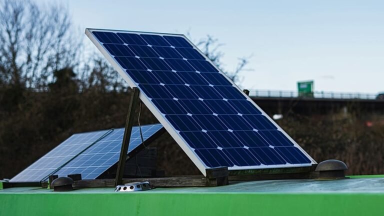A person holding a plug-in solar panel, with a fridge and a slow cooker in the background, showcasing the potential of solar power to energise our daily lives with renewable energy and sustainability