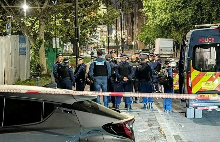 A descriptive image of a south London street, with a police cordon in place following a drive-by shooting at a BBQ, with people gathered nearby, looking concerned and shocked, with the primary keyword 'Brixton shooting' naturally included
