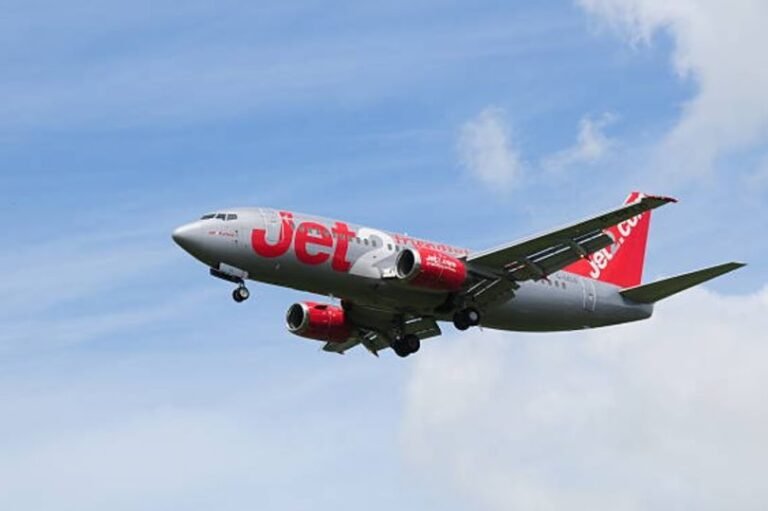 A Jet2 aircraft taking off from a runway, with a blue sky and fluffy white clouds in the background. The new pricing rule is expected to change the way passengers are charged for their flights, with a focus on transparency and customer satisfaction. Jet2 has announced plans to invest in new technology to enhance the booking process and provide more value to its passengers.