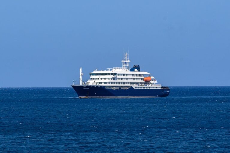 A polar expedition ship in the Arctic region, with a group of tourists and crew members on board, highlighting the risks of hantavirus outbreak in such extreme environments