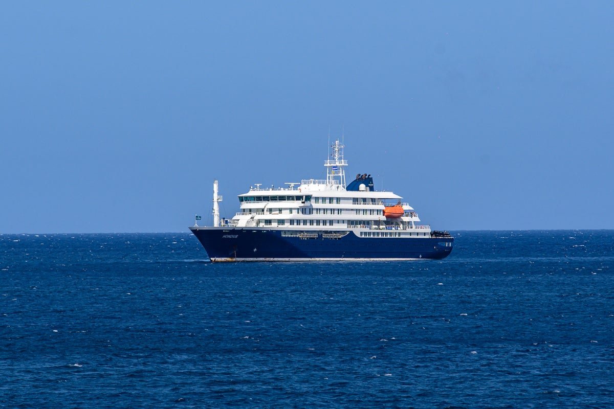 A polar expedition ship in the Arctic region, with a group of tourists and crew members on board, highlighting the risks of hantavirus outbreak in such extreme environments