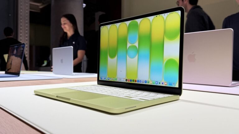 A person using a Windows 11 laptop in a coffee shop, with a MacBook Neo in the background, highlighting the primary keyword phrase Windows 11 laptops, with a focus on the UK market and the Signal65 report