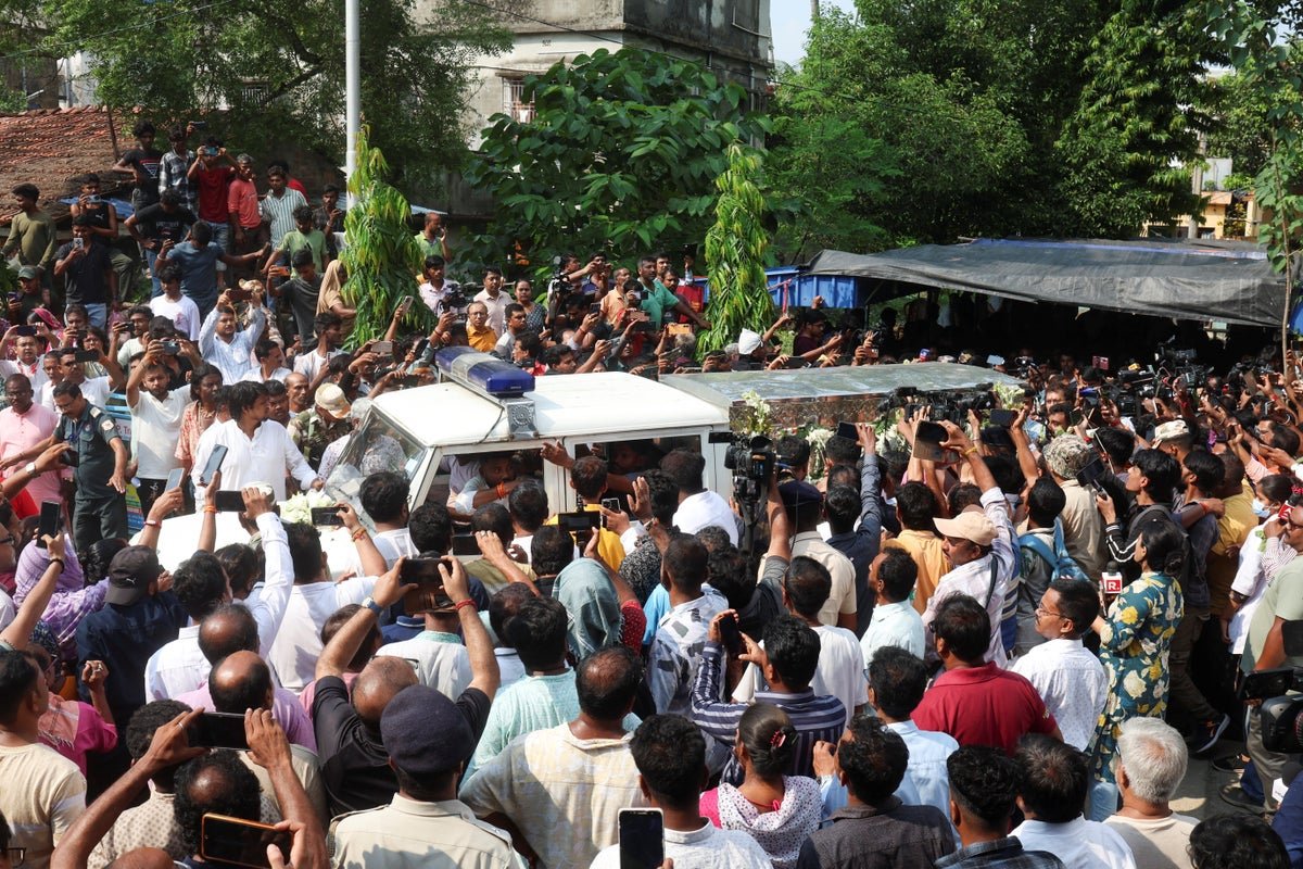 A descriptive image of the unrest in India, with people protesting and security forces deployed, highlighting the primary keyword of India unrest, with a colour palette of red and orange, symbolising the turmoil and chaos