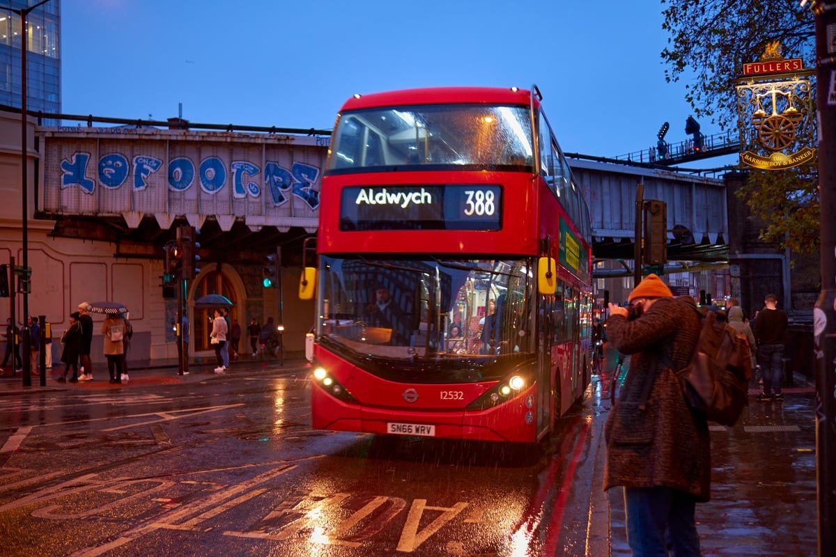 A descriptive image of a London bus with a Hopper package advertisement, highlighting the benefits of the new fare system for commuters and showcasing the city's commitment to sustainable transport