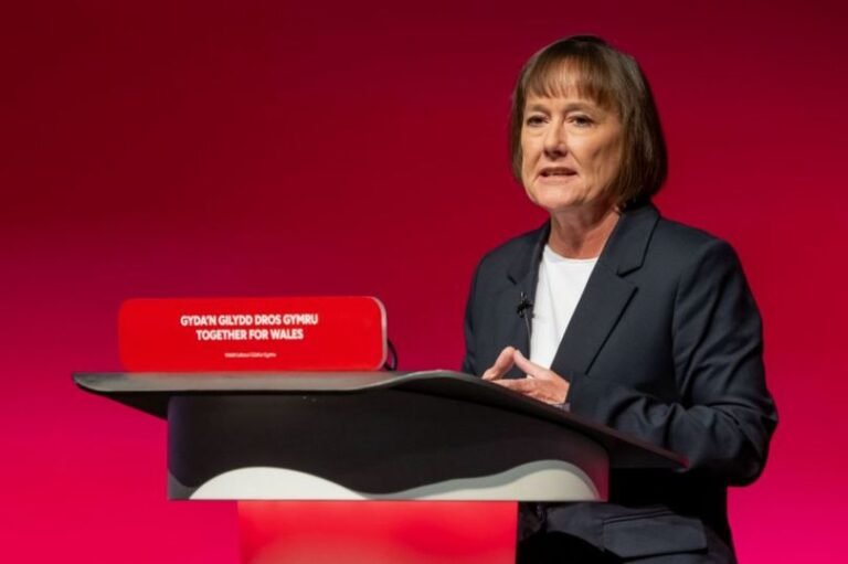 A car driving on a road with a 20mph speed limit sign, highlighting Welsh Labour's efforts to improve road safety through traffic management and speed limit implementation