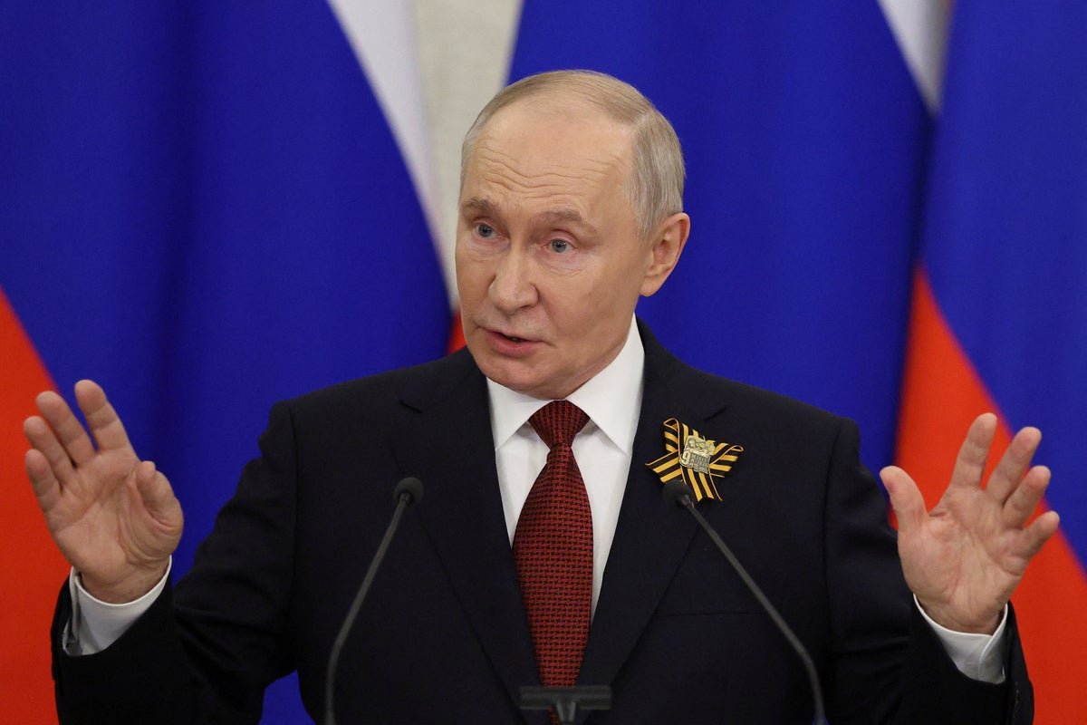 A photo of Putin speaking at a press conference, with a sombre expression, as the war with Ukraine rages on in the background, highlighting the ongoing conflict and humanitarian crisis