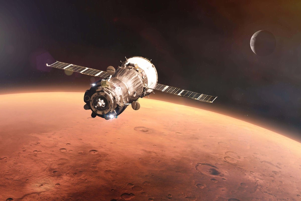 NASA spacecraft flying close to Mars in pursuit of rare metal asteroid, with the asteroid's distinct colour and behaviour making it a fascinating subject of study, as it has the potential to reveal valuable insights into the formation of our solar system and the universe